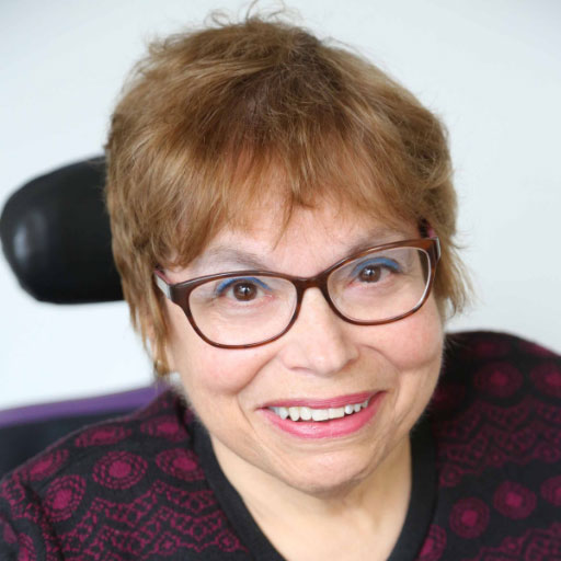 Photo of Judy Heumann with a short haircut and glasses.